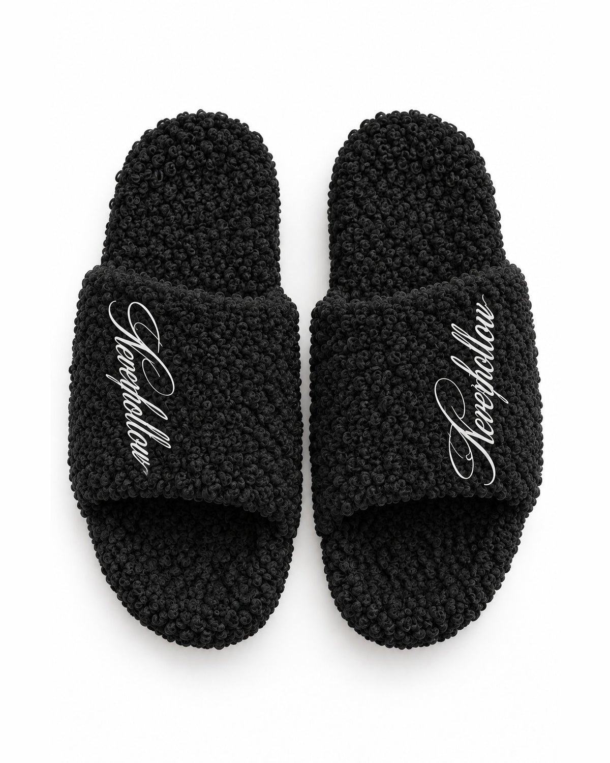 A pair of Haven Slides Obsidian seen from above, with the Neverhollow script on each strap