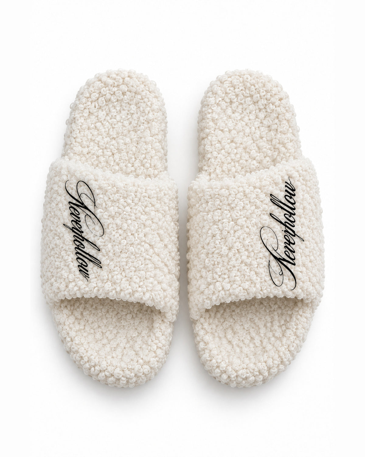 A pair of Haven Slides Bone seen from above, with the Neverhollow script on each strap